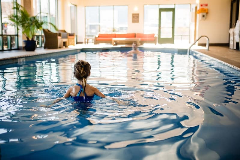 guest swimming in pool inside Comfort Inn & Suites Logan International Airport